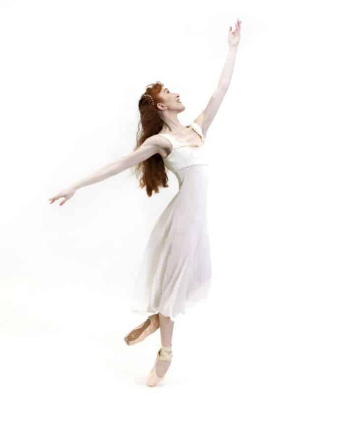 Image of a dancer with her arm in the air