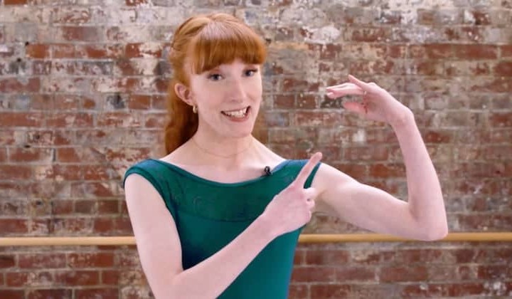 Image of a dancer pointing to their hand